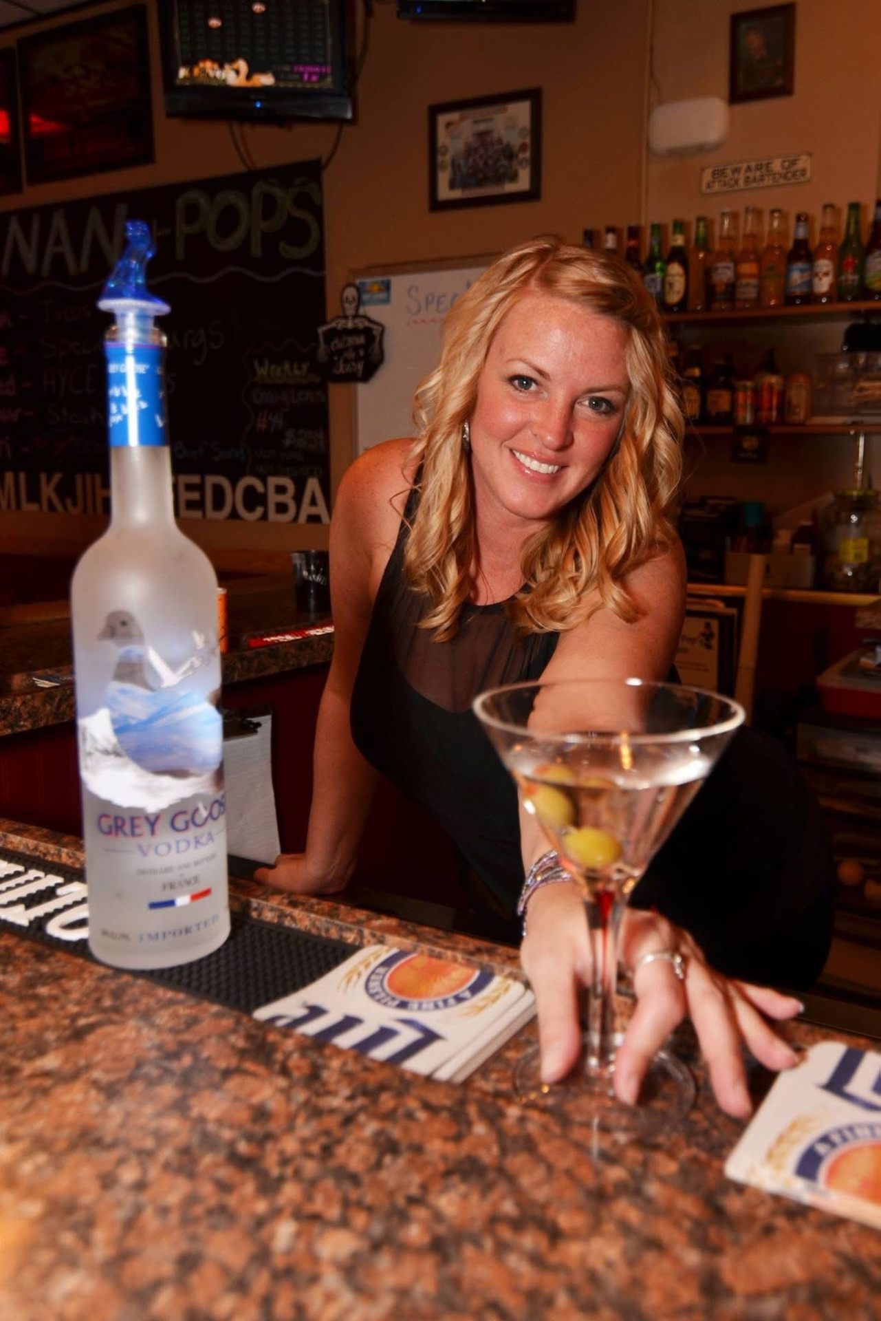 Bartender with martini and Grey Goose