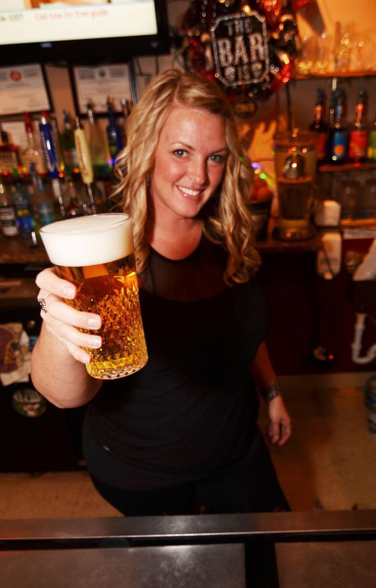 Bartender holding a pint of beer